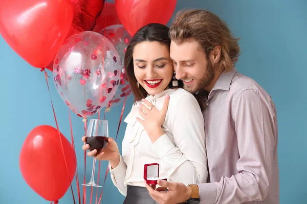 Young Man Proposing His Girlfriend Color Background Valentine Day Celebration — стокове фото