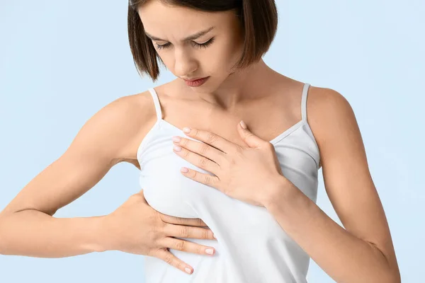 Young Woman Feeling Discomfort Her Breast Light Background Cancer Awareness — Stock Photo, Image