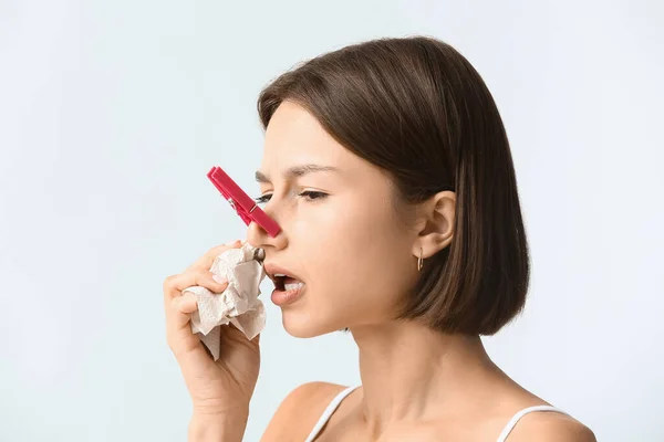 Ill Young Woman Clothespin Her Nose Light Background — 스톡 사진