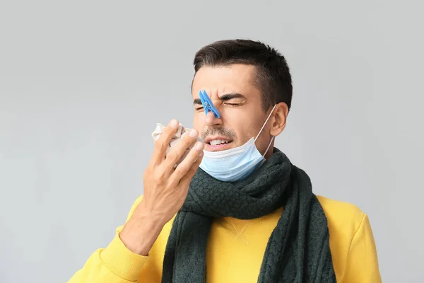 Ill Young Man Clothespin His Nose Grey Background — стоковое фото