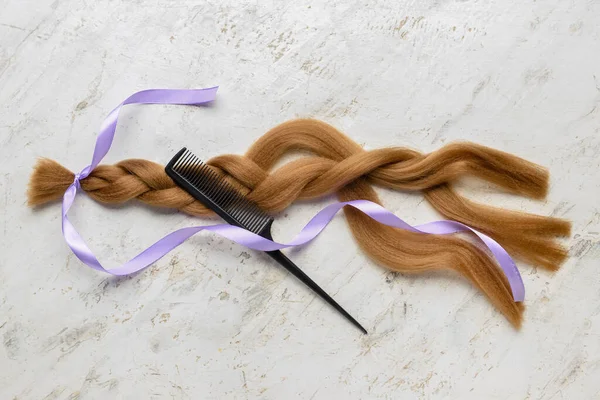 Braided Red Hair Donation Lilac Ribbon Comb Grunge Background — стоковое фото