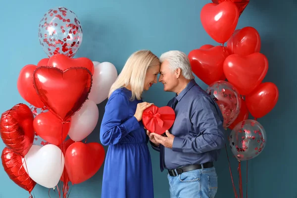 Happy Mature Couple Gift Balloons Color Background Valentine Day Celebration — стоковое фото