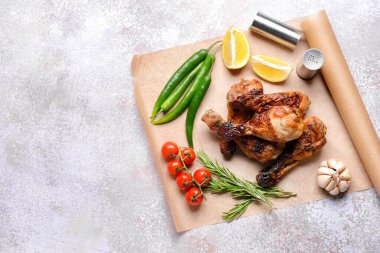 Arkaplanda pişmiş tavuk budu var.