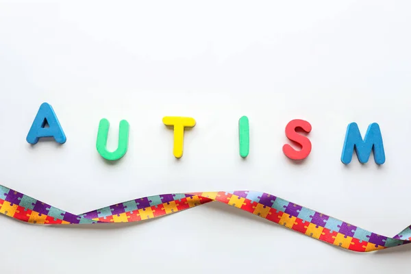 Word Autism Awareness Ribbon Light Background — Stock Photo, Image