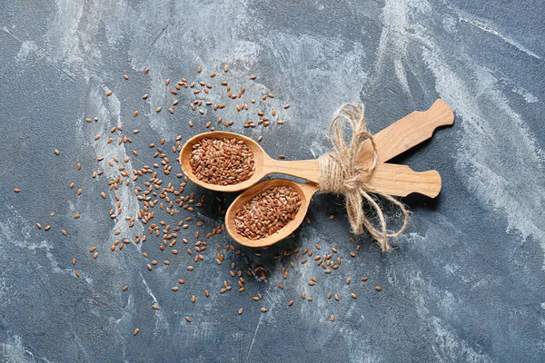Spoons Flax Seeds Color Background — стоковое фото