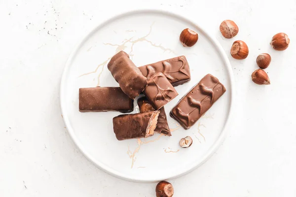 Plate Tasty Chocolate Nut Bars White Background — Stock Photo, Image