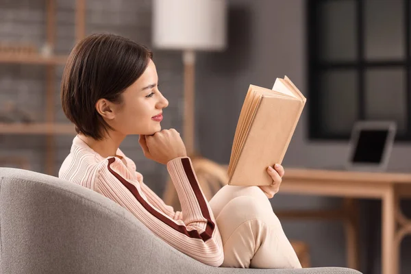 Beautiful Young Woman Reading Book Armchair Home — стоковое фото