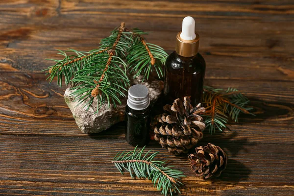 Bottles Essential Oil Fir Branches Cones Wooden Background — Stock Photo, Image