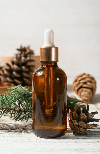 Bottle Essential Oil Fir Branch Pine Cones Light Wooden Background — Stock Photo, Image