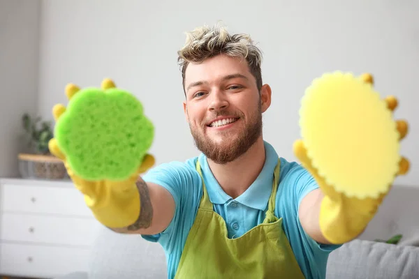 Handsome Young Man Different Cleaning Sponges Home — Stock Photo, Image