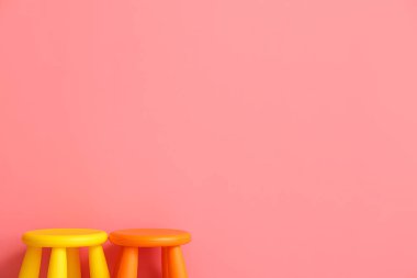 Child stools on color background
