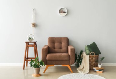 Interior of modern room with armchair near light wall