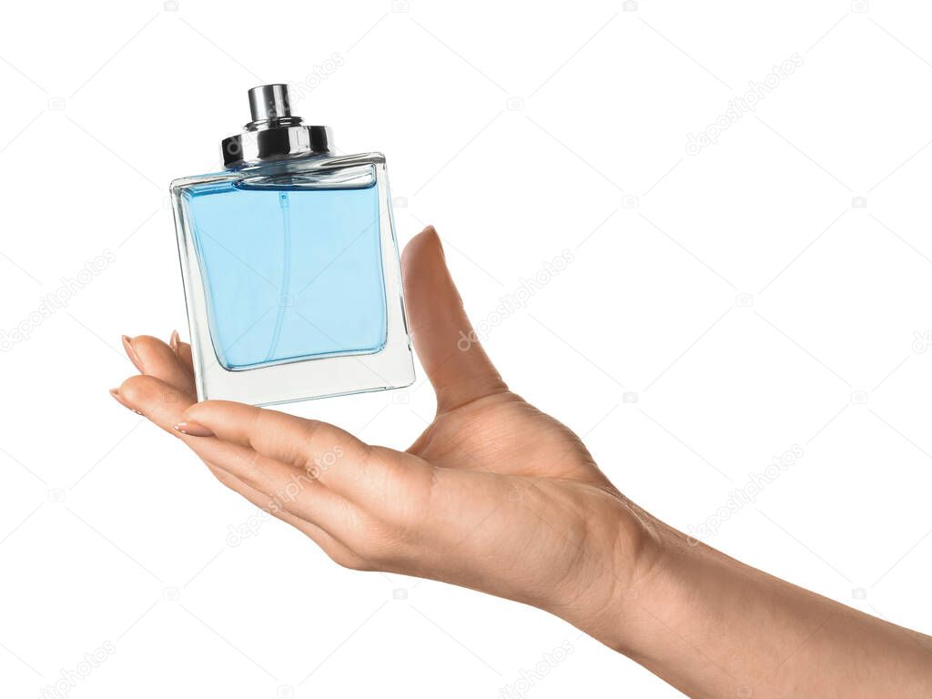 Female hand with bottle of perfume on white background, closeup