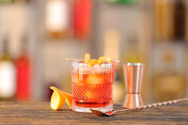Bulanık arka planda bir bardak lezzetli Negroni kokteyli.