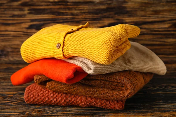 Stylish Baby Sweaters Wooden Background — Stock Photo, Image