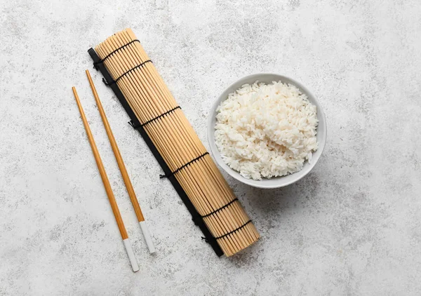 Bowl Tasty Boiled Rice Chopsticks Mat Light Background — Stock Photo, Image