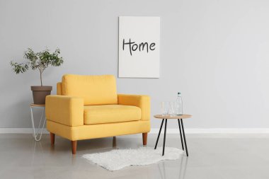 Sarı koltuklu, masa ve gözlüklü modern oturma odası.