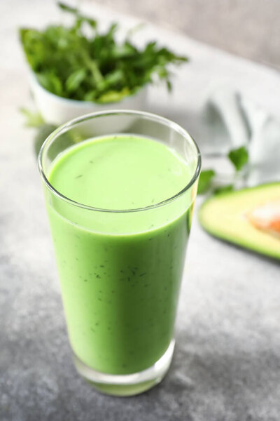 Glass of healthy green juice on table