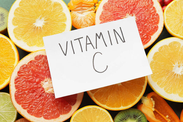 Text VITAMIN C and healthy products as background