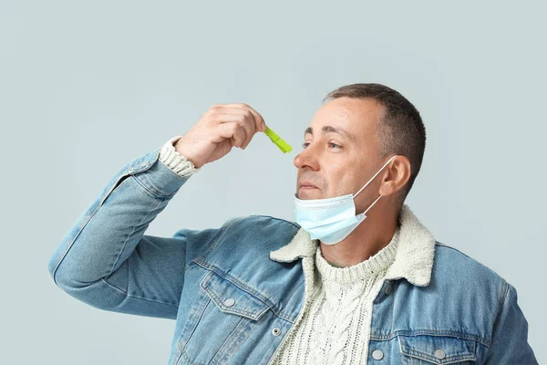 Ill Mature Man Clothespin Grey Background Stuffy Nose Concept — Stock Photo, Image