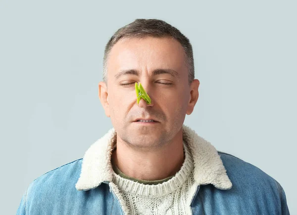 Ill Mature Man Clothespin His Nose Grey Background — Stock Photo, Image