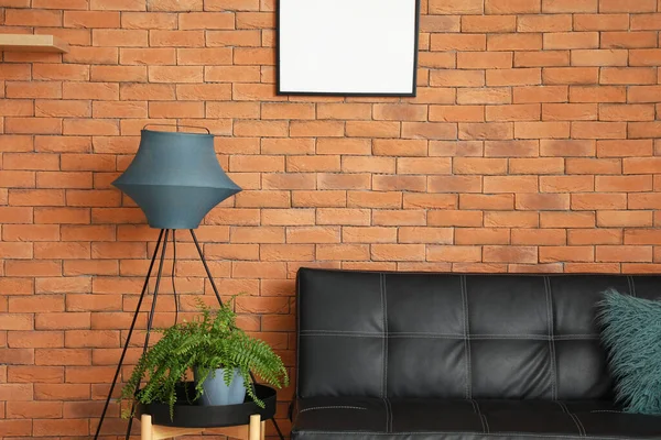 Table Houseplant Standing Lamp Couch Brick Wall — Stock Photo, Image