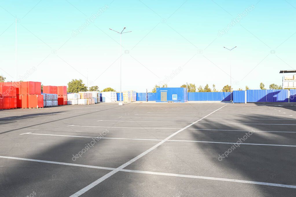 Empty parking lot near supermarket warehouse
