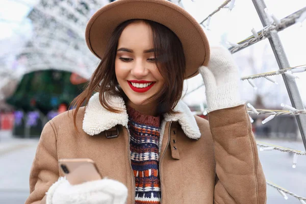 아름다운 미소짓는 여자가 겨울에 핸드폰을 사용하는 — 스톡 사진