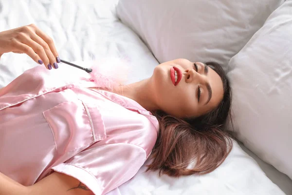 Young Woman Feather Stick Lying Bed — Stock Photo, Image