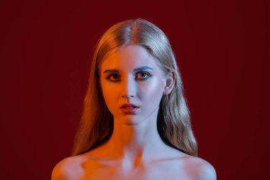 Renkli arka planda sıra dışı kaşları olan güzel bir kız.