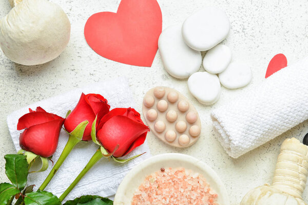 Beautiful spa composition with stones for Valentine's Day celebration on light background