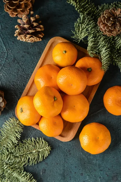 Wooden Board Tangerines Fir Branches Cones Dark Background — Stock Photo, Image