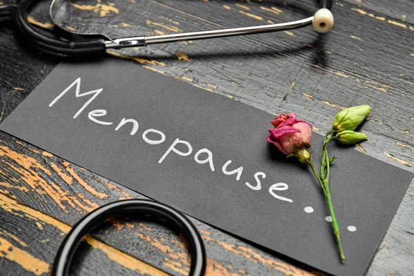 Paper Word Menopause Dried Rose Stethoscope Dark Wooden Background Closeup — Stock Photo, Image