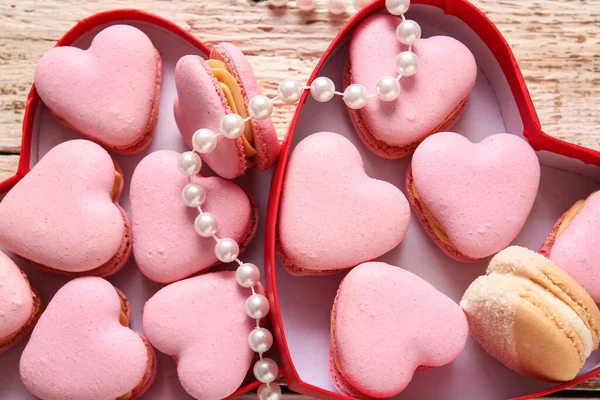 Boxes Tasty Heart Shaped Macaroons Beads Light Wooden Background — Stock Photo, Image