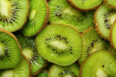 Arka plan olarak taze kivi dilimleri, yakın plan.