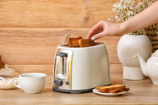 Woman Taking Bread Slice White Toaster Wooden Wall — Stock Photo, Image