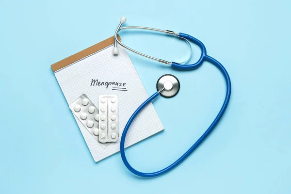Notebook Word Menopause Pills Stethoscope Blue Background — Stock Photo, Image