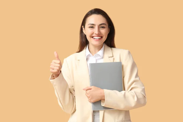 Pretty Young Businesswoman Folder Showing Thumb Beige Background — Stock Photo, Image