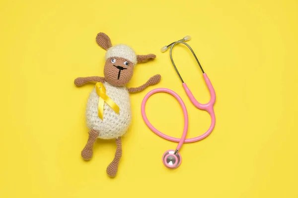 Toy Sheep Golden Awareness Ribbon Stethoscope Yellow Background International Childhood — Stock Photo, Image
