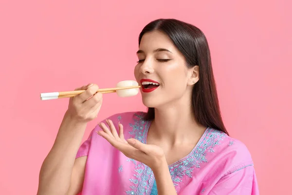 Beautiful Young Woman Eating Tasty Japanese Mochi Color Background — Stock Photo, Image