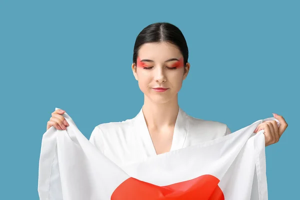 日本の国旗を背景に美しい若い女性 — ストック写真