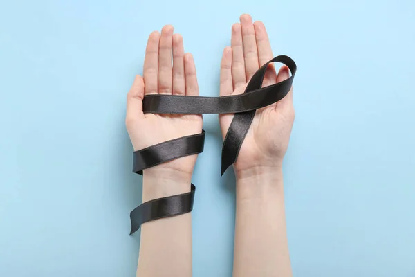 Female Hands Black Ribbon Blue Background Melanoma Concept — Stock Photo, Image