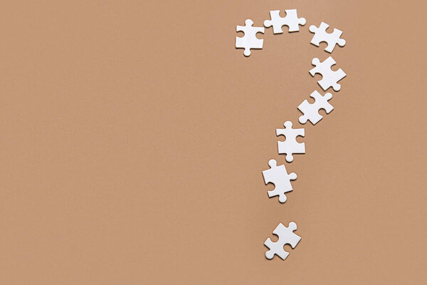 Question mark made of puzzles on color background