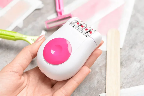 Female Hand Epilator Different Supplies Hair Removal Grunge Background — Stock Photo, Image