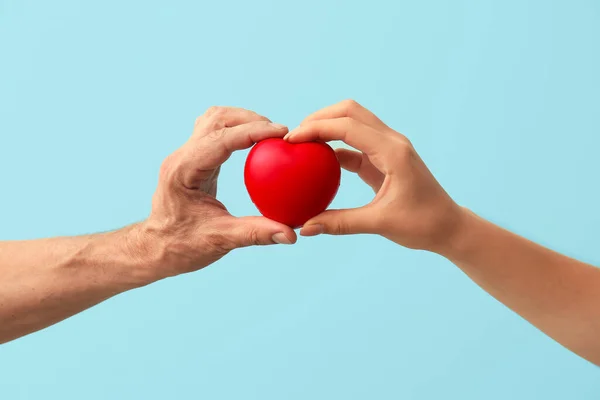 Man Woman Holding Red Heart Color Background Closeup Donation Concept — Stock Photo, Image