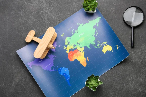 Magnifying Glass Wooden Plane Houseplants World Map Dark Background — Stock Photo, Image