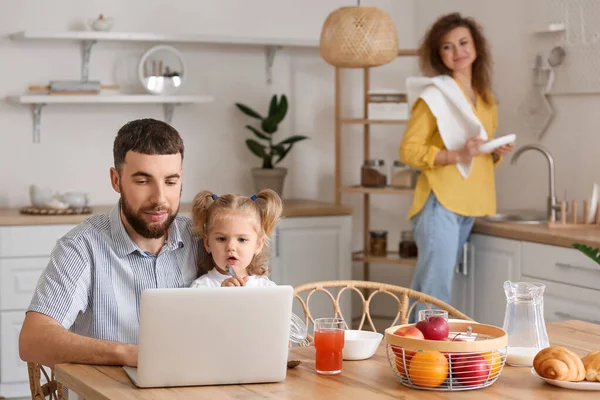 快乐的父亲和他的小女儿在家里的厨房里带着笔记本电脑 — 图库照片