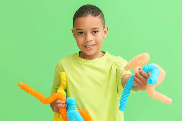 Little African American Boy Pop Tubes Green Background — Stock Photo, Image