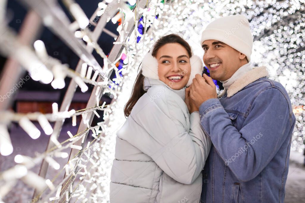 Loving couple holding hands at winter night