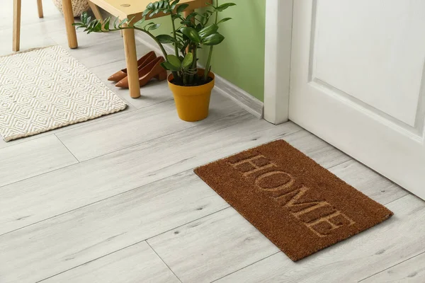 Brown door mat on floor in hallway